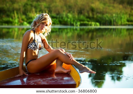 portrait of a woman in a swim suite outdoors, in a boat