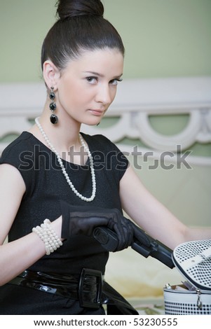 retro woman with a gun in a hotel woman