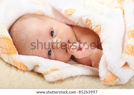 Curious baby face with soft cover on sheep leather
