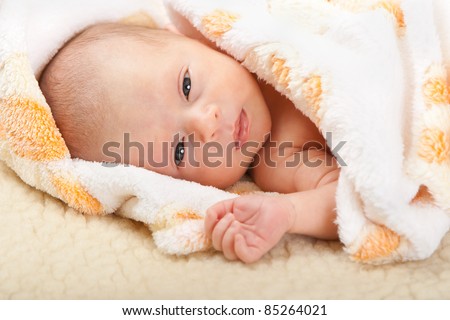 Baby face with soft cover on sheep leather