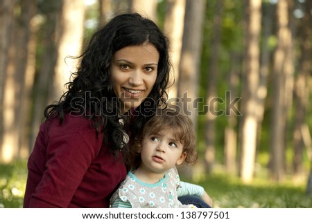 Mother and daughter outside in the park