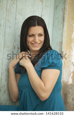 Dark haired woman touching her hair