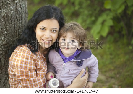 Beautiful woman and little girl outdoors