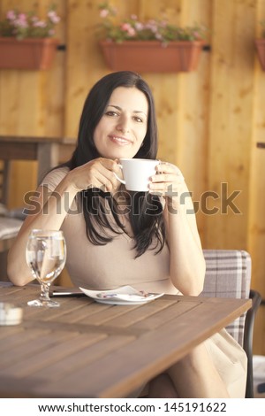 Girl with coffee in a restaurant