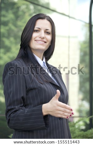 Business woman reaching for a handshake
