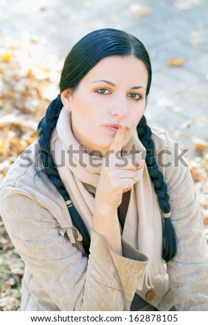 Beautiful young woman is telling you to be quiet