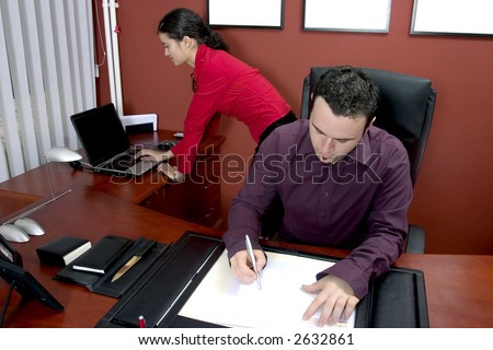 Businessman in his office writing document