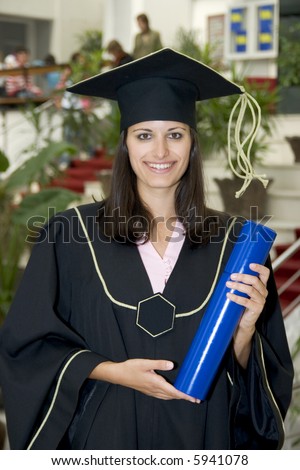 student graduating in black gown holding blue diploma