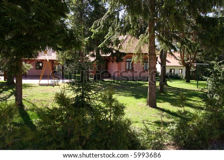 small cottages and high trees on mountain Zlatibor in Serbia