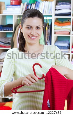 stock photo housewife putting clothes on available space hanger shelves