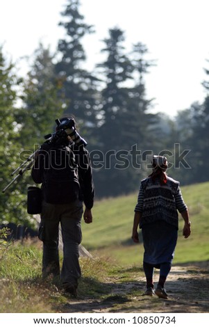 Woman and man on a path in the sunny day