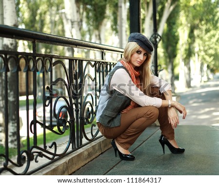 Young old fashioned girl siting on the street