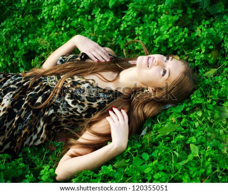 Close up portrait young dreaming girl on green grass