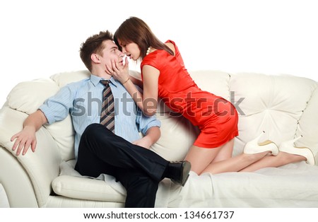 Temptation, emotional relationship, a passionate young couple on a couch, studio, on white