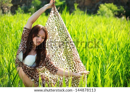 Attractive sensual woman in green cane field, on nature