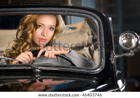 beautiful woman in an old car