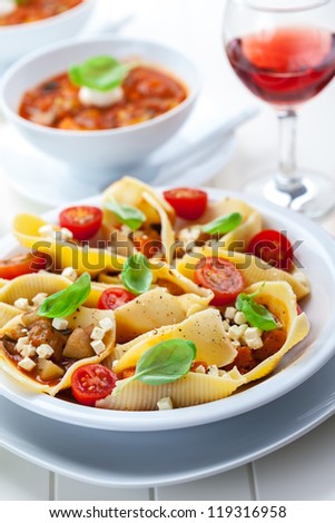 Pasta with vegetable stew with red wine and minestrone soup in back