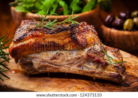 Roasted pork with salad and olives