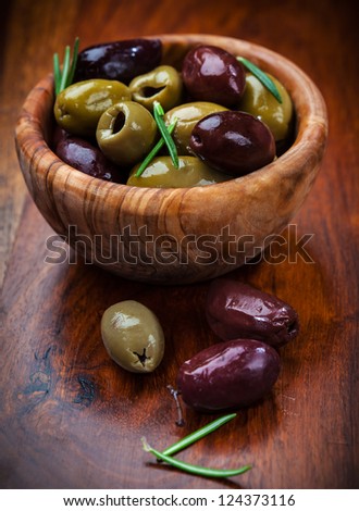 Delicious green and black olives in the bowl