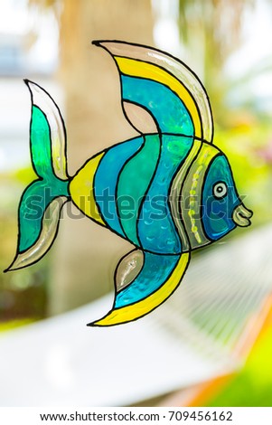 Window painting of fish made by window colors