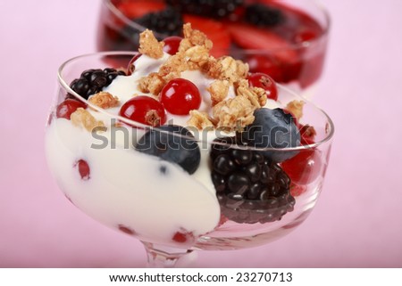 Three yogurts in the glass with fruits and cereal