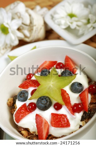 White yogurt in the bowl with fruits and cereal