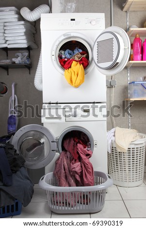 Baskets of dirty laundry in the washing room with dryer and washing machine