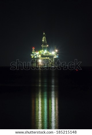 A night view of the oil drilling platform lit up on the coast of Limassol, in Cyprus. The oil rig is floating in the Mediterranean sea and is ready for drilling for natural gas appraisal.