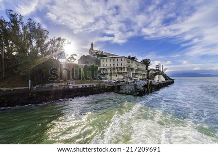 SAN FRANCISCO,USA - FEBRUARY 28,2014: The Alcatraz Penitentiary in Frisco,California,United States of America.View of the island,pier,wharf, prison buildings and the San Francisco Bay on a sunny day.