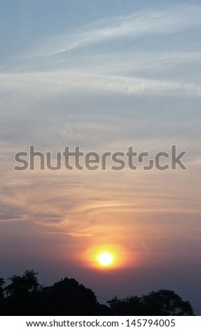 sunset on blue sky with white clouds