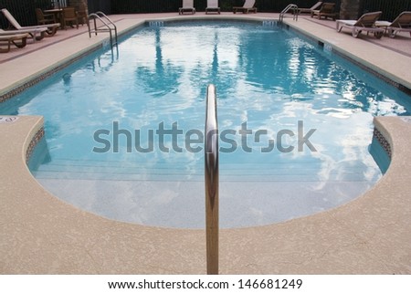 Swimming pool blue water with white cloud reflection