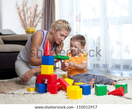 cute mother and child boy playing together indoor