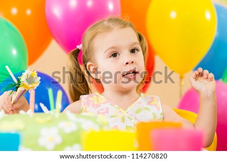 kid girl eating cake on party birthday