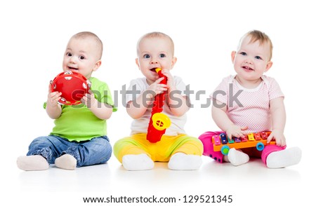 Funny babies girls group with musical toys isolated Funny babies girls group with musical toys isolated