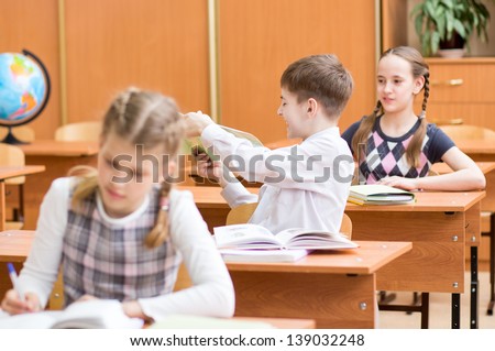 school children at lesson in classroom