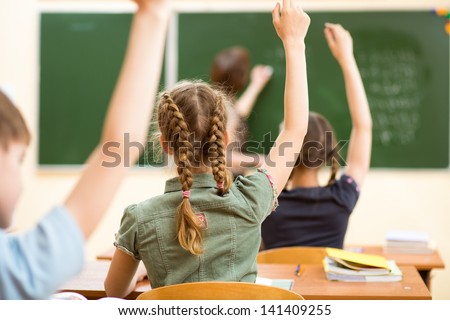 School Children In Classroom At Lesson