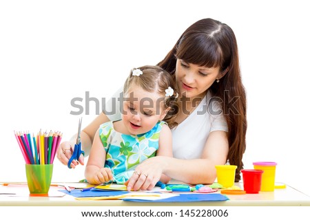 Mother with child girl draw and cut together Mother with child girl draw and cut together