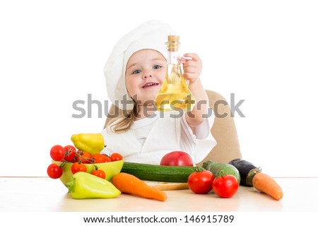 baby girl with healthy food vegetables and sunflower oil