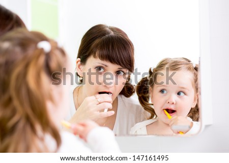 Mother Teaching Kid Teeth Brushing