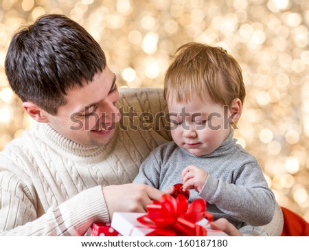 father and son with gift over festival background