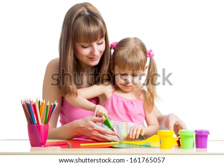 Mother and child draw and cut together