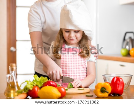 Mom And Child Cooking At Kitchen