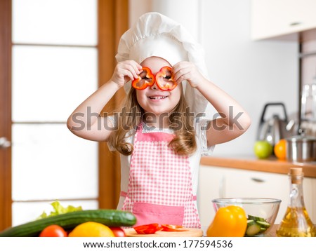 Funny chef girl cooking at kitchen