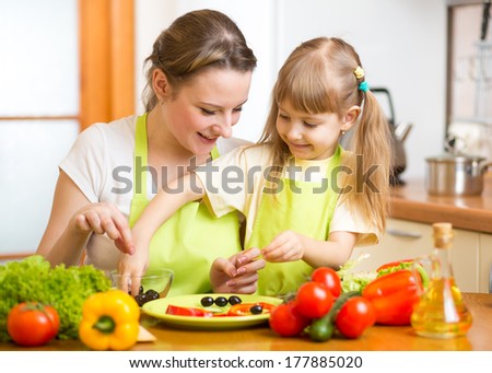 mother and kid daughter cooking in the kitchen