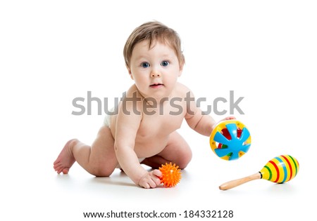 funny baby boy playing with musical toys