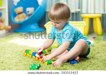 child boy playing with block toys indoor