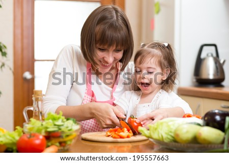 mom and child cooking at kitchen