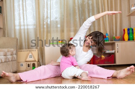 mother and kid doing gymnastic at home