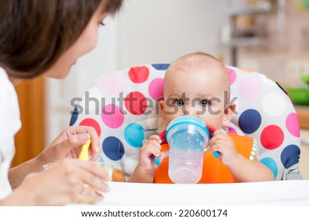 mom feeding her kid