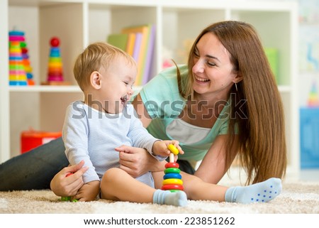 cute mother and kid boy play together indoor at home